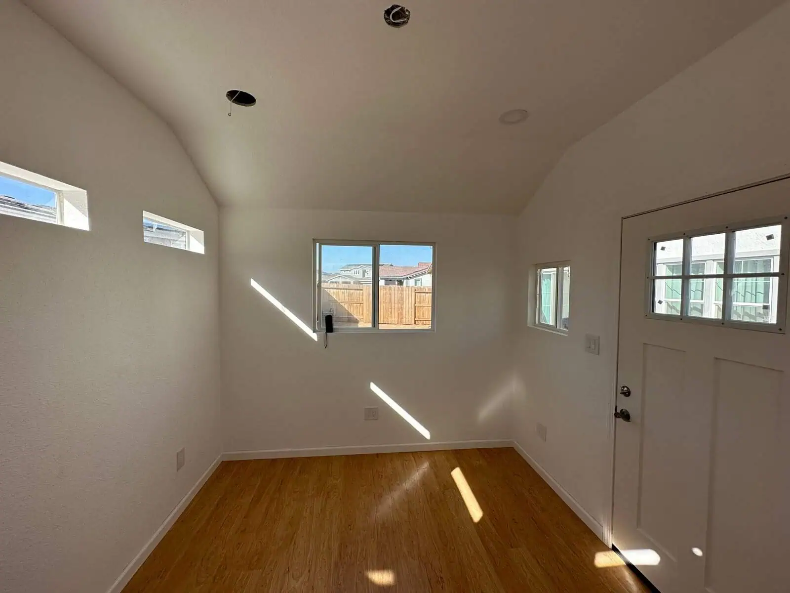 Bright, airy room featuring multiple windows and fresh white walls, perfect for a cozy home living s.